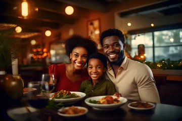Fotobehang Portrait of happy African American family having dinner in restaurant, Love and warmth, Black people © rabbizz77