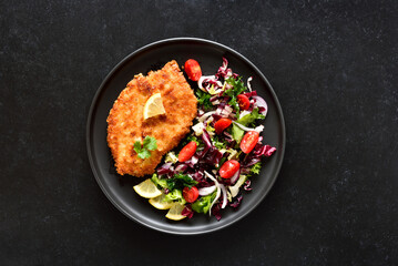Chicken schnitzel and vegetable salad on plate - obrazy, fototapety, plakaty