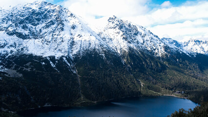 Czarny Staw pod Rysamy or Black Pond lake near the Morskie Oko Snowy Mountain Hut in Polish Tatry mountains, drone view, Zakopane, Poland. Aerial view shot of beautiful green hills and mountains in © anna.stasiia