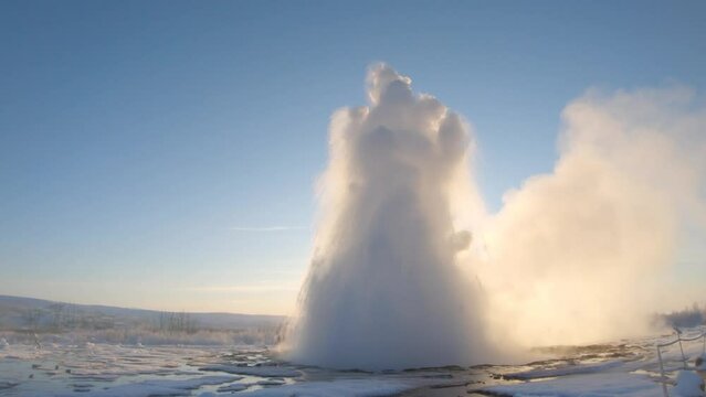 Powerful Geysir eruption in Iceland in Winter at sunrise