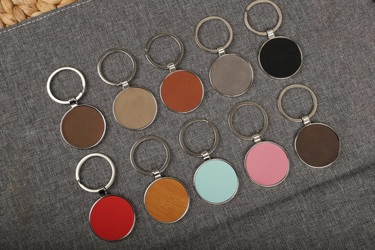 Metal and leather keychains. Colorful one side leather; Square, rectangle and circle shaped key rings. Concept shots, photos taken specially for e-commerce sales.
