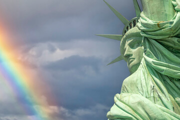 statue of liberty on a rainbow blue and clouds sky background