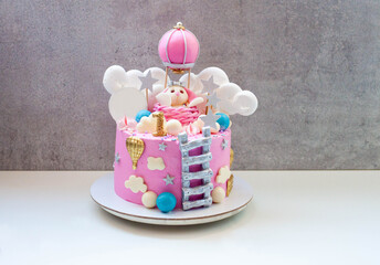 Beautiful pink cake for girl's birthday with fondant bunny, ladder, clouds, balloons, stars, moon...