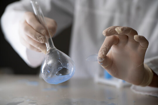 broken chemical glass flask with liquid on the table