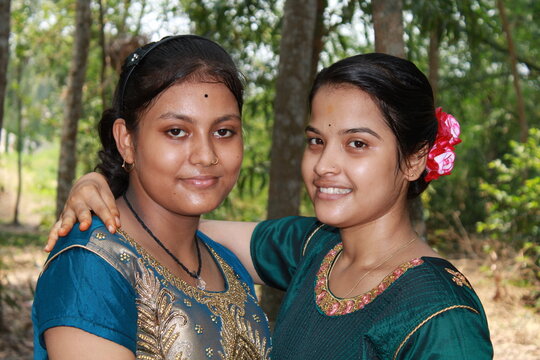 Two Indian Asian collage girl students or friends posing for photograph