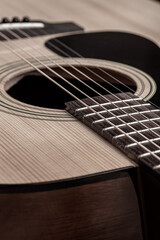 Obraz premium Classical guitar close up. Acoustic guitar on wood background.Music instrument concept