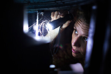 Adult Woman Trying To Fix Electricity by Checking Security Valve System of Old Industrial Complex