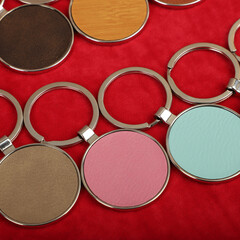 Metal and leather keychains. Colorful one side leather; Square, rectangle and circle shaped key rings. Concept shots, photos taken specially for e-commerce sales.