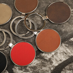 Metal and leather keychains. Colorful one side leather; Square, rectangle and circle shaped key rings. Concept shots, photos taken specially for e-commerce sales.