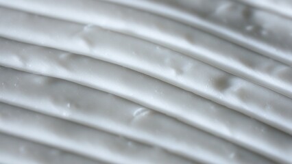 Beauty and skin care products advertisement creative concept. Close up shot of cream background. Face or body white cream fluid texture with strokes. Smooth moisturizer cream shot.