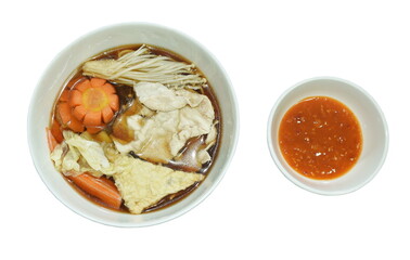 boiled shabu shabu slice pork and crab stick with vegetable in black soy soup dipping sauce on white background