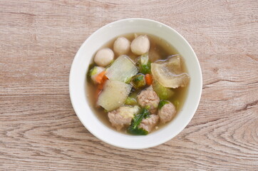 boiled chop pork with fish ball couple cabbage topping seaweed in clear soup on bowl