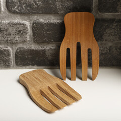 Wooden salad hands, bamboo kitchen utensils, bamboo salad hands, wooden salad spoons, close-up and concept shot. e-commerce photos, free space for writing,