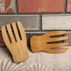 Wooden salad hands, bamboo kitchen utensils, bamboo salad hands, wooden salad spoons, close-up and concept shot. e-commerce photos, free space for writing,