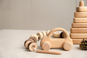 Eco friendly plastic free toys. Modern wooden toys: pyramid, car, lacing toy. Motor skills...