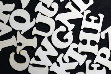 English wooden letters on black background