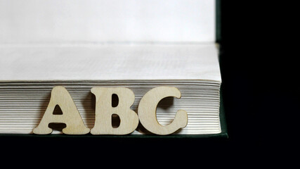 ABC wooden letters and book, English dictionary