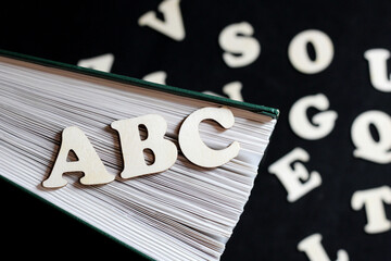 English wooden letters and book