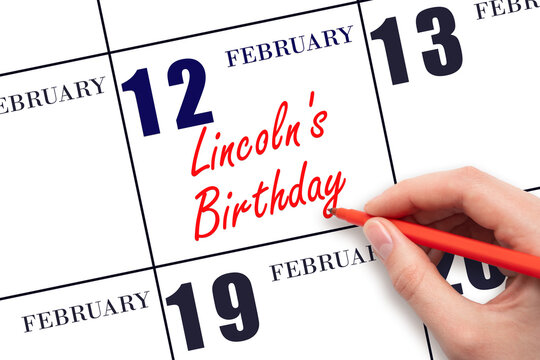 February 12. Hand writing text Lincoln's Birthday on calendar date. Save the date. - Powered by Adobe