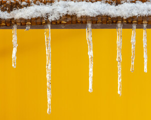 Icicles on a yellow background