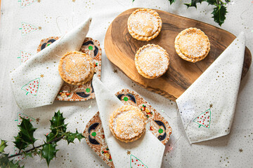 Christmas mince pies on a wooden board on a table © Liz Mitchell