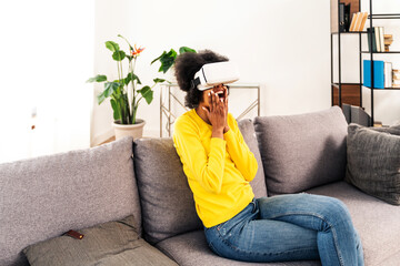 Beautiful woman playing at home with VR headset