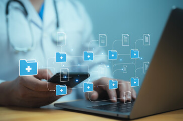 A medical worker works with an electronic database and documents.Technology and access information,...