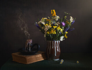 A bouquet of wildflowers and an extinguished candle,