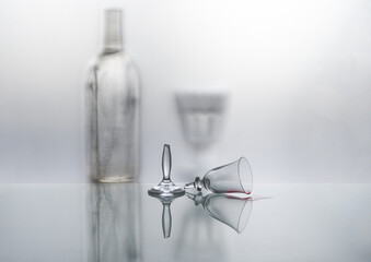 Glassware is reflected in the mirror surface. Broken glass. Soft, blurred background.