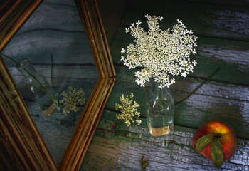White wildflowers reflected in the mirror.