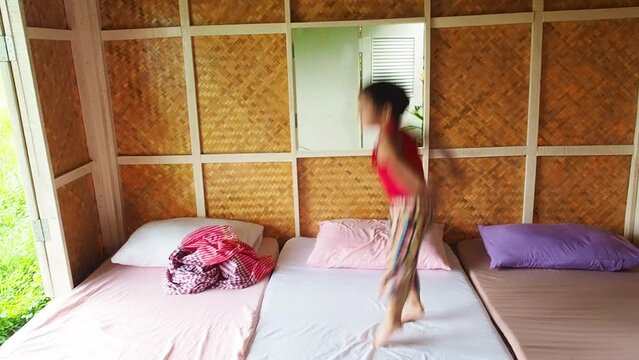 a kid jumping on the bed on home stays travel
