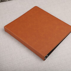 Personalized binding, leather folder cover, leather binding, binder, binder, office binding, corporate gift. Concept shot leather binding, top view, colorful