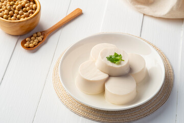 Fresh Sliced Soft Tofu soy bean curd on white plate