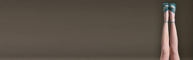 blue shoes with heels on legs of elegant woman in white pantyhose on grey background, banner