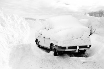 Car covered by a snowdrift