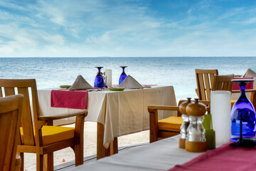Romantic table setting in tropical restaurant on the beach