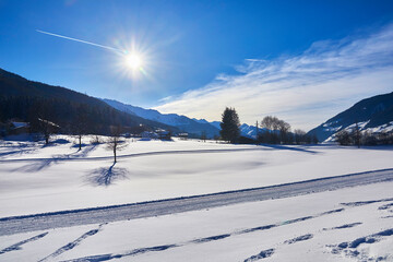 Winterpanorama mit Langlaufloipe im Salzburger Land bei Bramberg, in Österreich.
