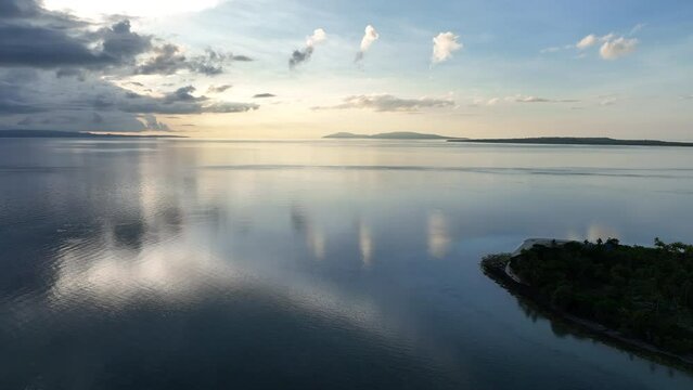 A serene sunrise illuminates the remote island of Koon near Seram, Indonesia. This scenic island's coral reefs, and the surrounding seas, support extraordinary marine biodiversity.