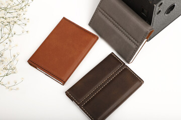 Colored leather business card holder, Genuine leather business card holder, concept shot, top view, different color, clamshell and stitched card holder. White backgorund.