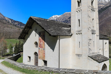 The catholic church of Santa Maria del Castello under the foot of Mesocco ruins. The church is well-known for its wall paintings inside in late romantic style.