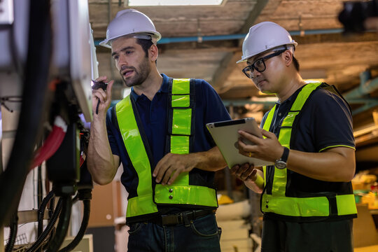 Electrical engineer working in control room. Electrical engineer man checking Power Distribution Cabinet in the control room