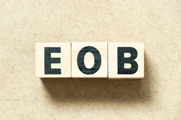Alphabet letter block in word EOB (Abbreviation of end of business) on wood background