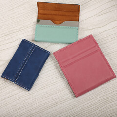 Colored leather business card holder, Genuine leather business card holder, concept shot, top view, different color, clamshell and stitched card holder