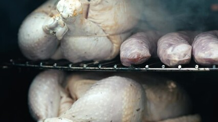 Chicken and sausage in a smoker box outside 