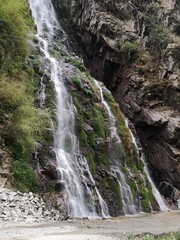 A majestic and powerful waterfall, its cascading waters gush forth abundantly, creating a...