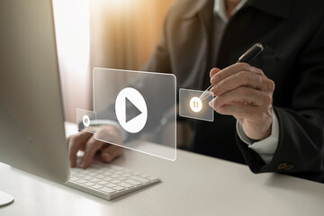 Businessman using mouse and keyboard watching Video streaming on internet, live concert, content...