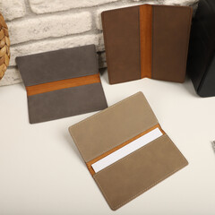 Colorful leather checkbook. Genuine leather checkbook, concept shot, top view, different color, clamshell and stitched checkbook