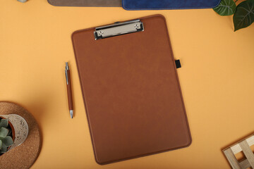 Colorful leather clipboard. Genuine leather clipboard, concept shot, top view, different color, clamshell and stitched clipboard. Brown color clipboard