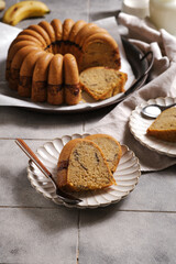 slice of homemade marble cake on a rustic plate with rustic grey tiles background