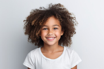 Happy african american child girl smiling to camera on pink background